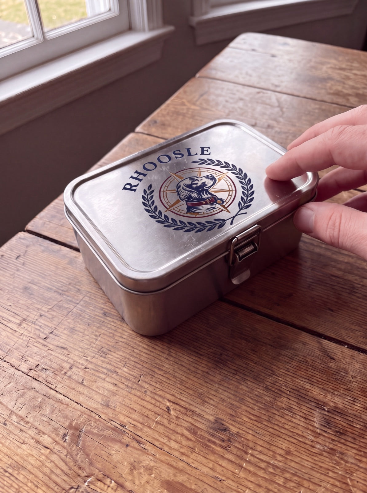 A Rhoosle tin on a wooden table
